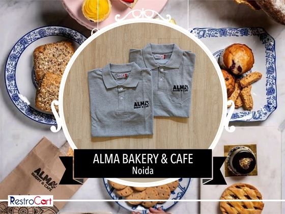 Two grey polo t-shirts with black printed logo on the chest, folded, custom made for Alma Bakery by RestroCart, New Delhi