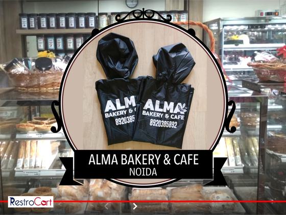 Two black hooded windcheaters with large white logo and phone number printed on the back, custom made for Alma Bakery by RestroCart, New Delhi