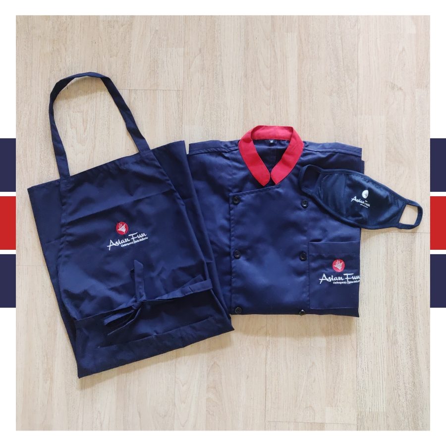 Navy chef coat with red contrast collar and matching apron, custom kitchen uniforms made for Asian Fun by RestroCart