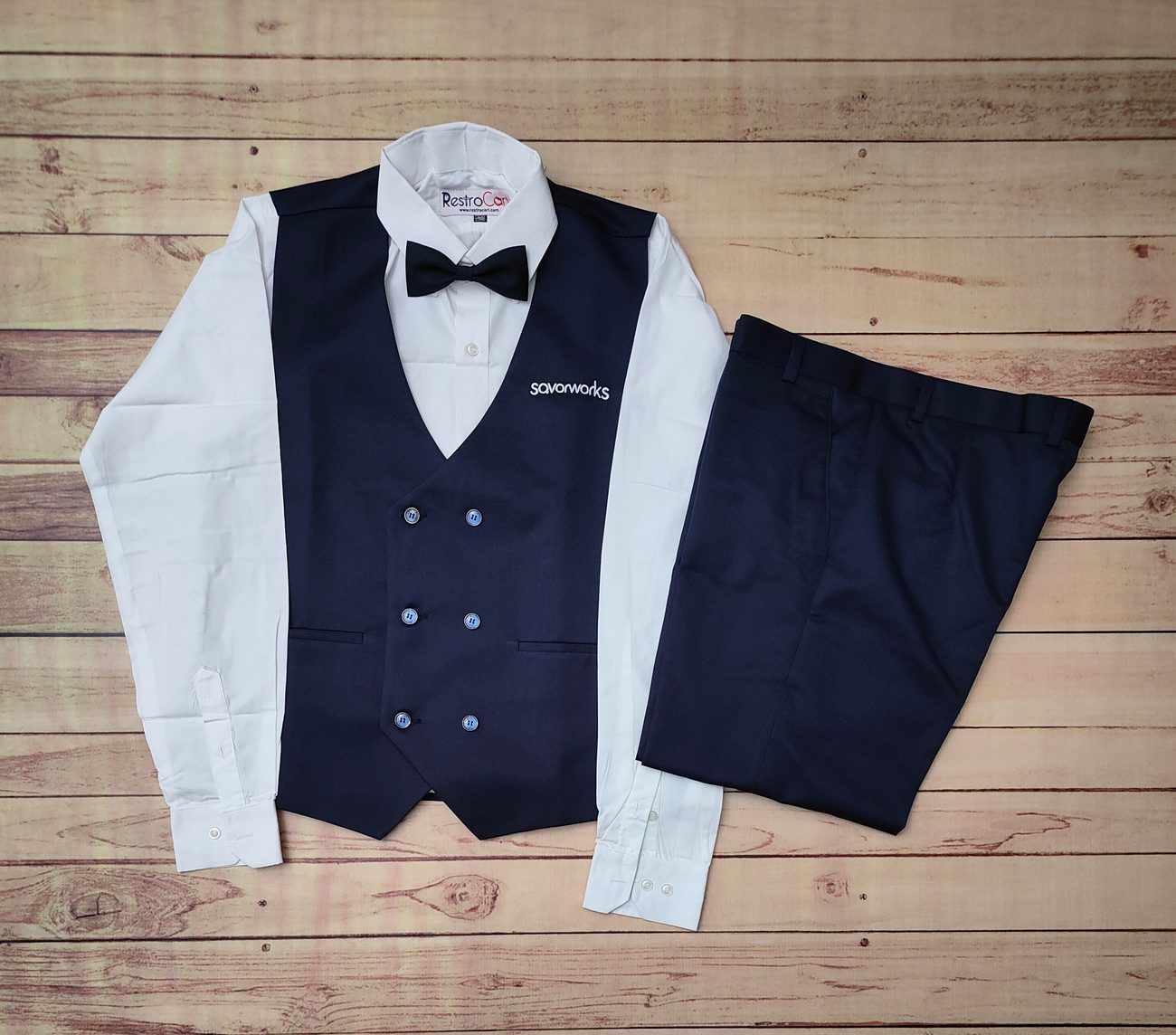 Custom bartender uniforms with rolled-sleeve shirts and leather bar aprons made by RestroCart