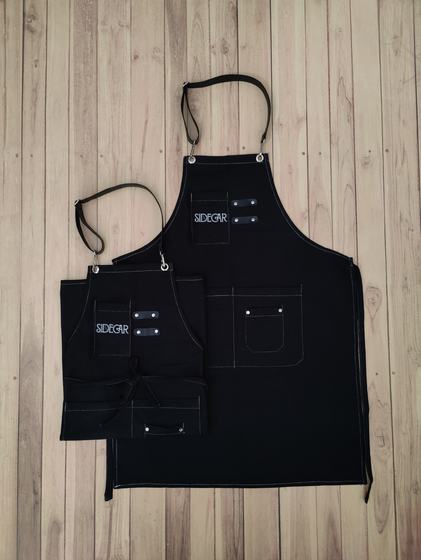 Black canvas bib and waist apron pair with white stitching and printed chest logo, custom made by RestroCart, New Delhi