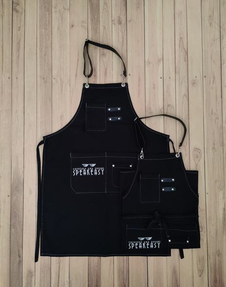 Black canvas bib and waist apron pair with white stitching and white printed logo, custom made by RestroCart, New Delhi