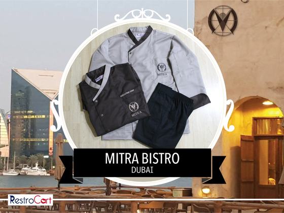 Grey chef coat with black collar, black chef coat with logo and black trousers, laid flat, custom made for Bistro Mitra by RestroCart, New Delhi