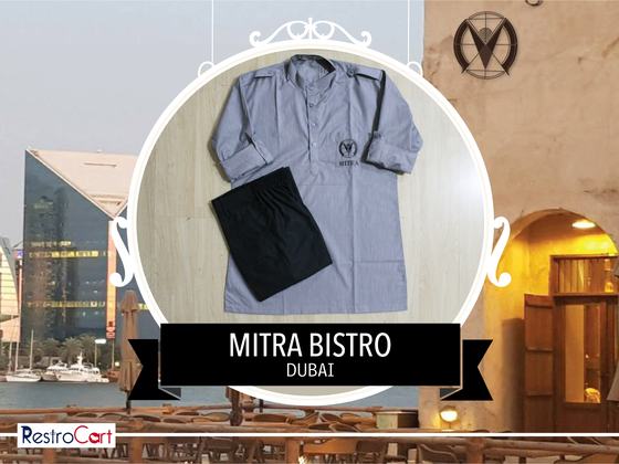Grey-blue three-quarter sleeve housekeeping tunic with small logo and black trousers, custom made for Bistro Mitra by RestroCart, New Delhi