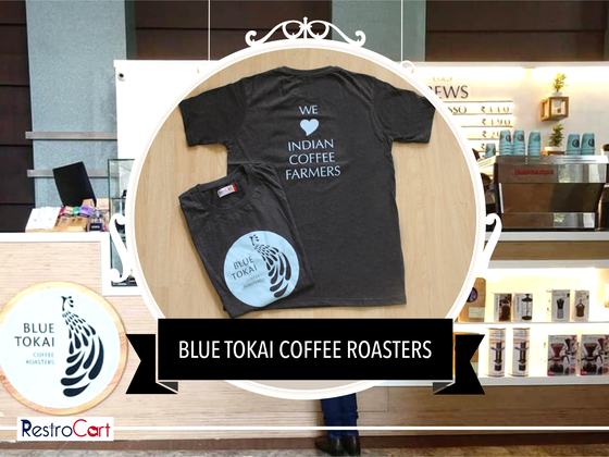 Charcoal t-shirts with white heart slogan print and a light blue logo, folded, custom made for Blue Tokai Coffee Roasters by RestroCart, New Delhi