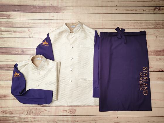 Cream textured Nehru jackets with purple sleeves and orange logo beside purple waist apron, custom made by RestroCart, New Delhi