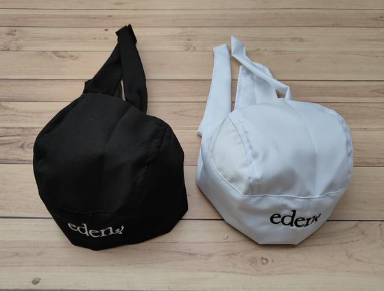 Black and white chef skull caps with back ties and contrast printed script logo, custom made by RestroCart, New Delhi
