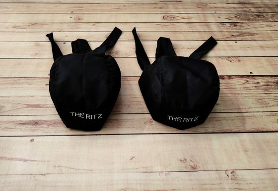 Small black chef skull caps with back ties and white printed wordmark on the front, custom made by RestroCart, New Delhi