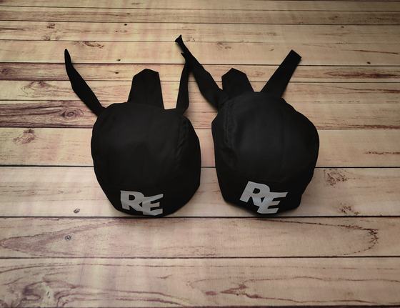 Black chef skull caps with back ties and large grey printed two-letter logo, custom made by RestroCart, New Delhi