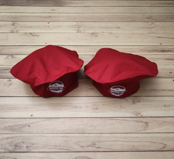 Red mushroom-top chef caps with red band and white printed round badge logo, custom made by RestroCart, New Delhi