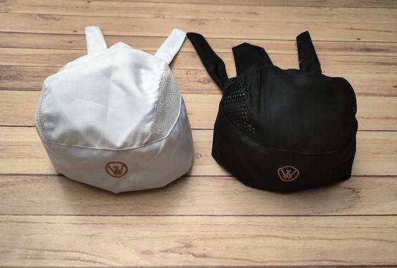 White and black mesh-top chef skull caps with back ties and orange round logo, custom made by RestroCart, New Delhi