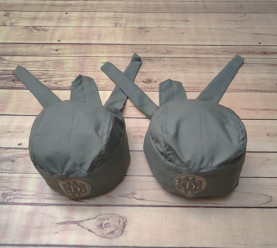 Sage grey chef skull caps with back ties and embroidered tan badge logo on the front, custom made by RestroCart, New Delhi