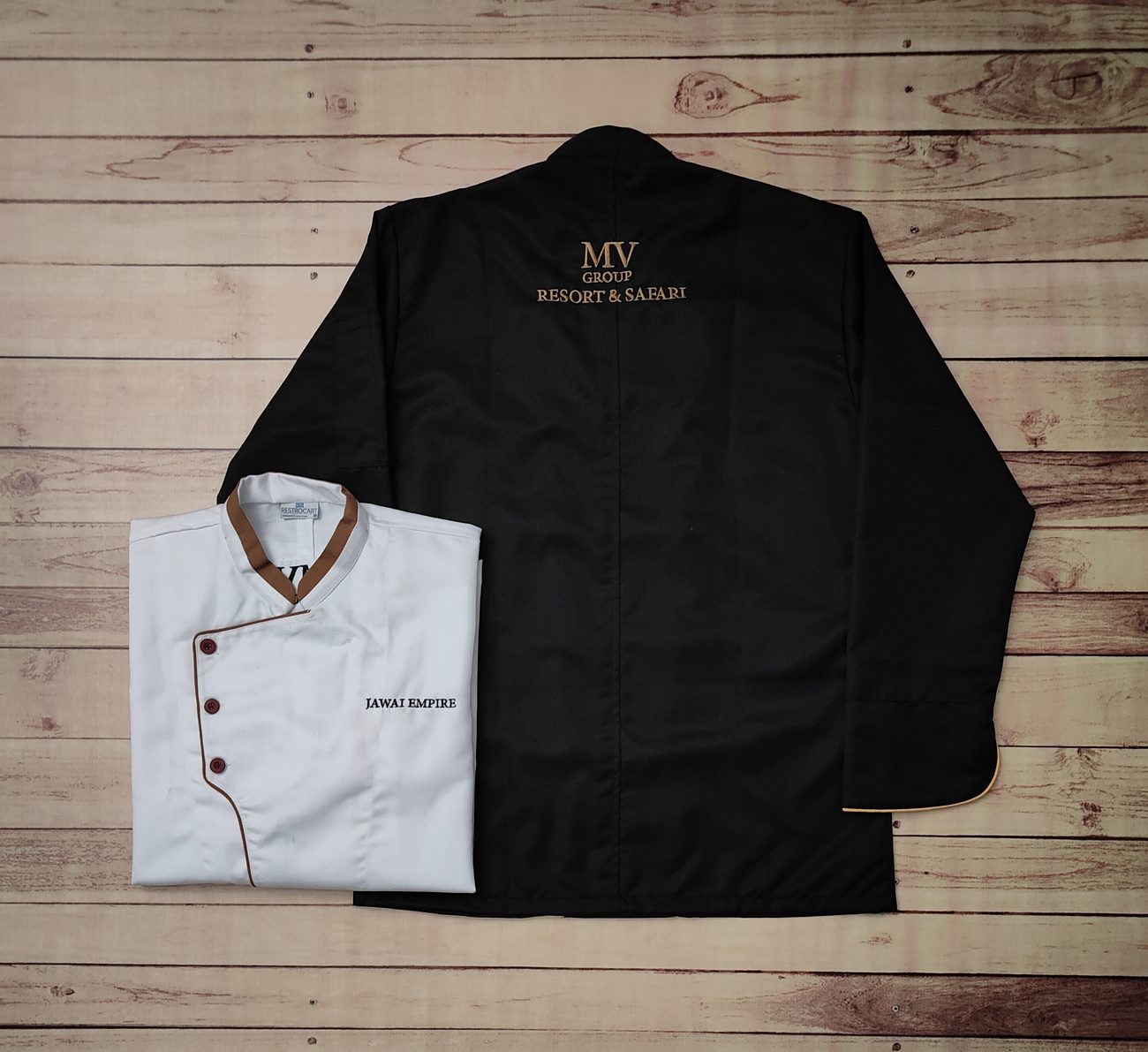 Black and white custom chef coats with embroidered branding, hygienic kitchen uniforms made by RestroCart, New Delhi
