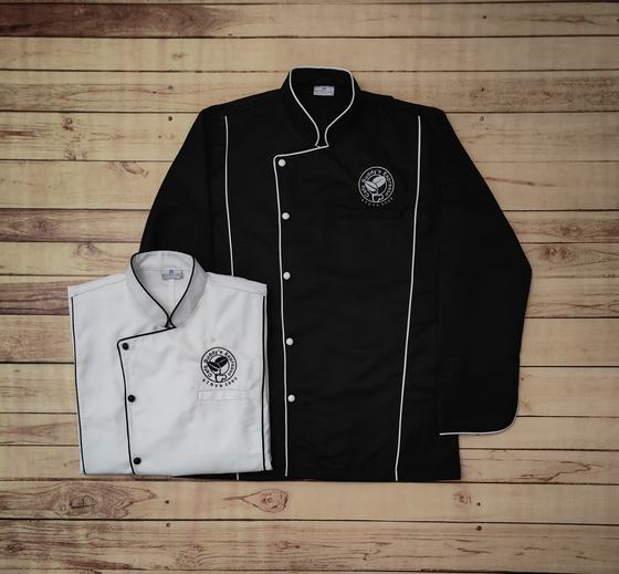 Black chef coat with white piping and a folded white coat with black piping, round crest logo, custom made by RestroCart, New Delhi