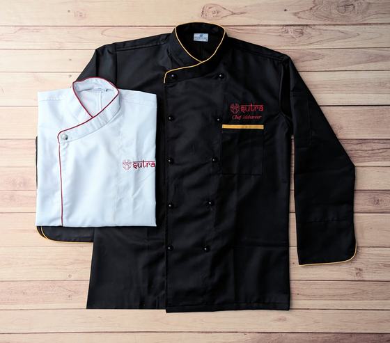Black chef coat with gold piping and folded white coat with red piping, red embroidered logo, custom made by RestroCart, New Delhi