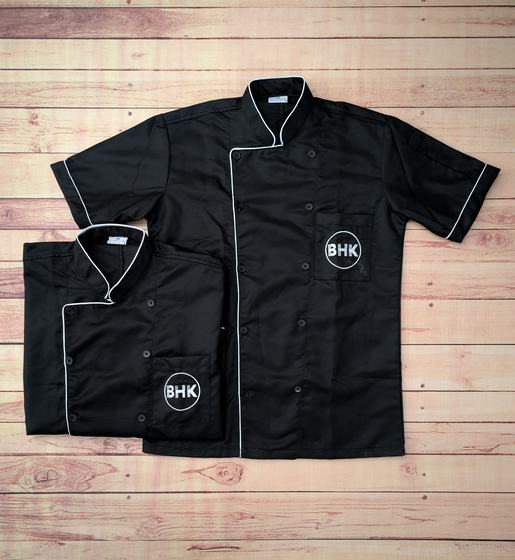 Black short sleeve chef coats with white piping and white round embroidered initials logo, custom made by RestroCart, New Delhi