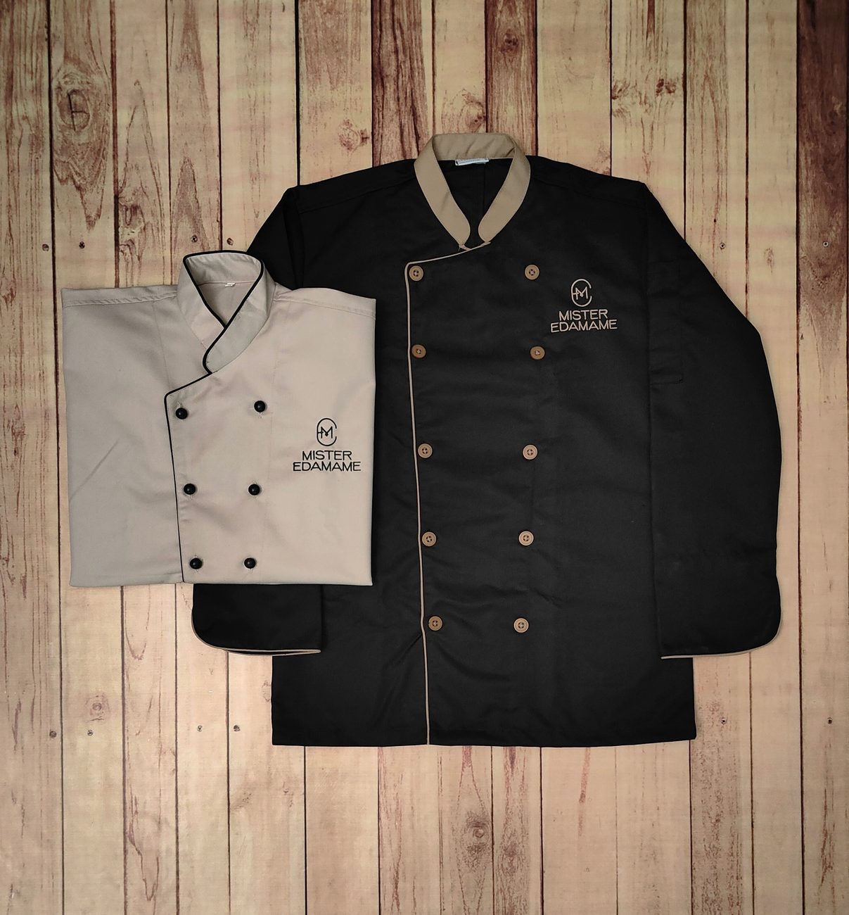 White and black custom chef coats with contrast piping, chef uniforms made by RestroCart, New Delhi