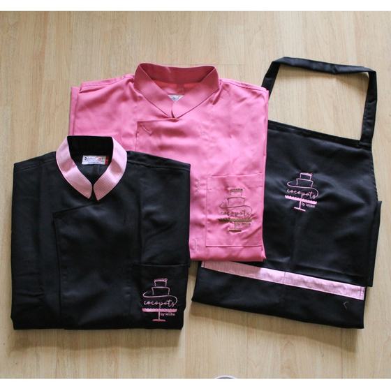Pink and black chef coats with contrast collars and black bib apron, all with pink cake logo, custom made for Cocopots by RestroCart, New Delhi