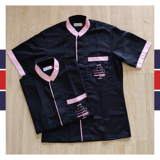 Black housekeeping tunics with pink collar, piping and pocket trims and cake logo, two sizes, custom made for Cocopots by RestroCart, New Delhi