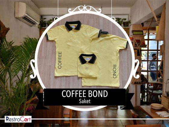 Two pale yellow polo t-shirts with black collar and printed wordmark down the side, custom made for Coffee Bond by RestroCart, New Delhi