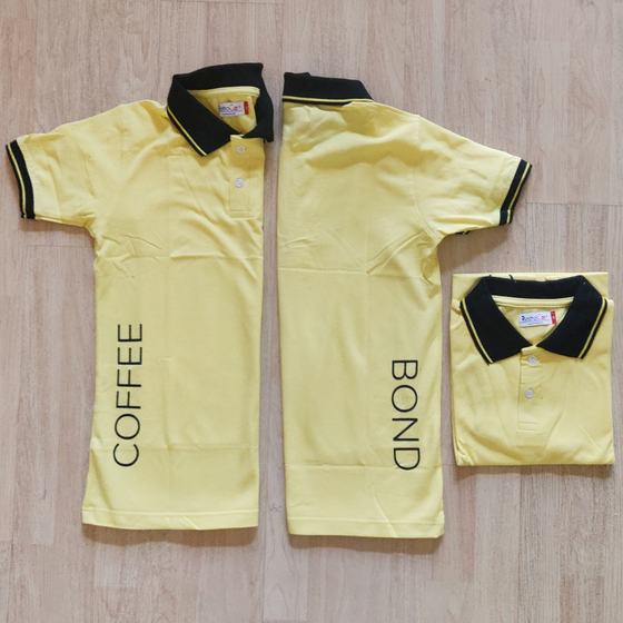 Pale yellow polo t-shirts with black tipped collar and black printed vertical lettering on back, custom made for Coffee Bond by RestroCart, New Delhi