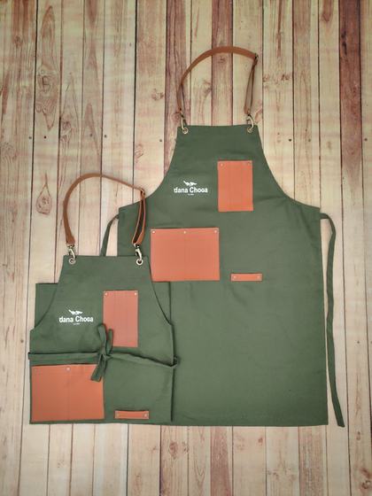 Olive green canvas apron pair with orange leatherette pockets and white printed logo, custom made by RestroCart, New Delhi