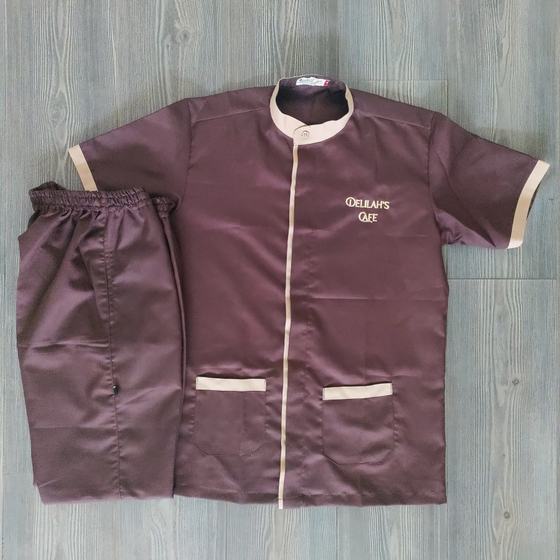 Brown housekeeping tunic with beige collar and pocket trims and script logo, with trousers, custom made for Delilah by RestroCart, New Delhi