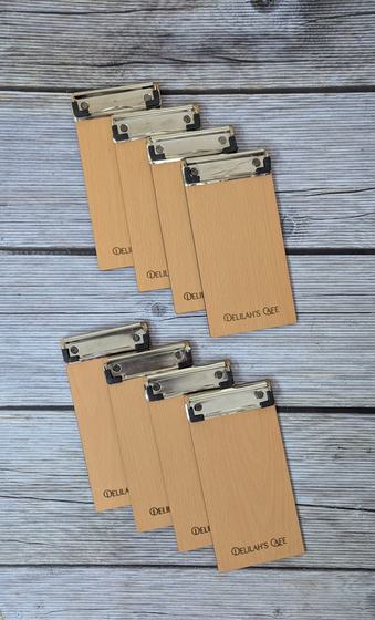 Light wood MDF bill holders with steel clips and printed logo, set of eight on wood, custom made for Delilah by RestroCart, New Delhi