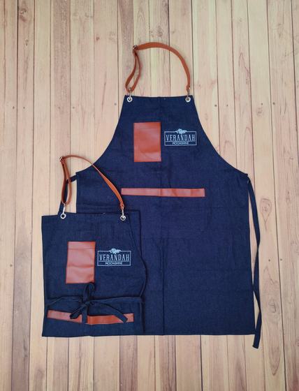 Two denim bib aprons with tan leatherette neck strap, pocket patch and trim, and printed logo, custom made by RestroCart, New Delhi
