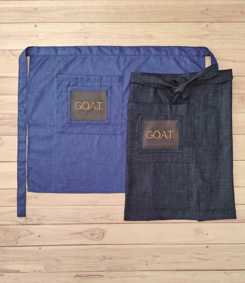 Blue and charcoal denim waist aprons with brown leatherette logo patch on the pocket, custom made by RestroCart, New Delhi
