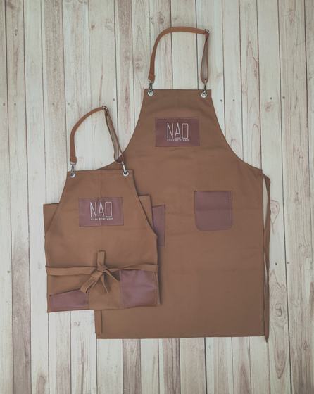 Brown canvas bib and waist apron pair with leatherette logo patches and pockets, custom made by RestroCart, New Delhi