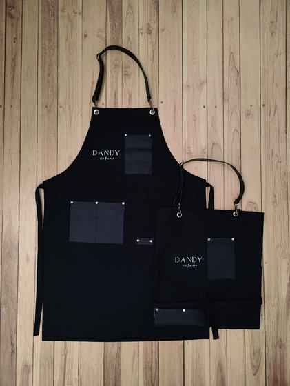 Black canvas bib and waist apron pair with leatherette pockets and small serif logo print, custom made by RestroCart, New Delhi