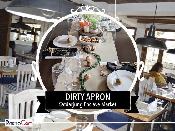 Dining table set with beige table runner, black cloth napkins, plates and wine glasses, custom made for Dirty Apron by RestroCart, New Delhi