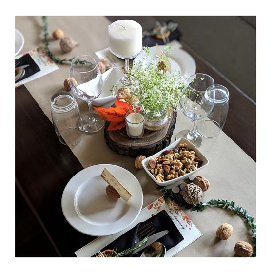Styled dining table with runner, wine glasses, plates, candle and printed menu cards at places, custom made for Dirty Apron by RestroCart, New Delhi