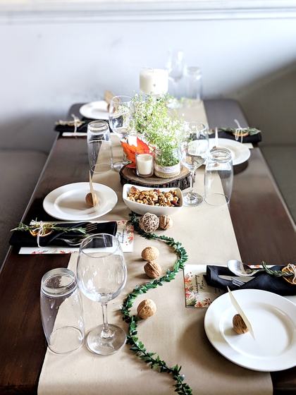 Kraft table runner with black napkins, white plates, glasses and green garland table setting, custom made for Dirty Apron by RestroCart, New Delhi