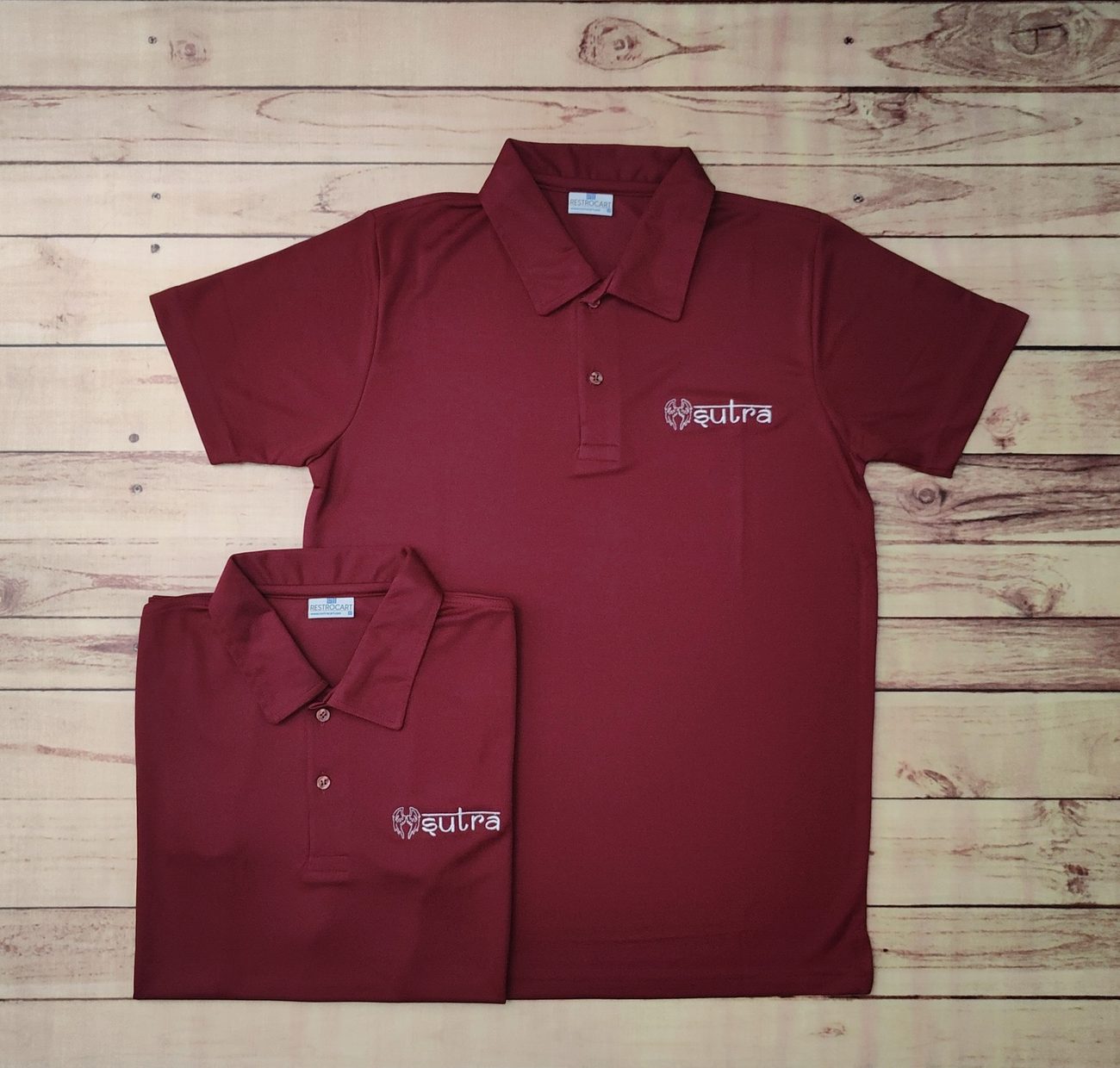 Maroon custom dry-fit polo t-shirt uniforms with embroidered Sutra branding, made by RestroCart, New Delhi