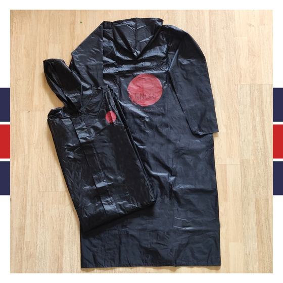 Black plastic hooded raincoat with red round printed logo, laid flat, custom made for Enoki Kitchen by RestroCart, New Delhi