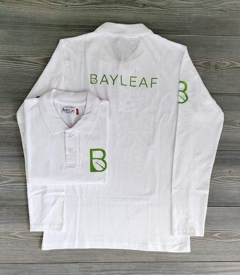 White full sleeve polo t-shirts in two sizes with green printed leaf initial logo and sleeve name, custom made by RestroCart, New Delhi