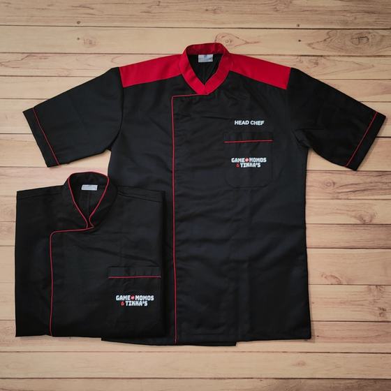 Black chef coats with red shoulder yoke and piping, embroidered logo and head chef title, custom made for Game of Momos by RestroCart, New Delhi