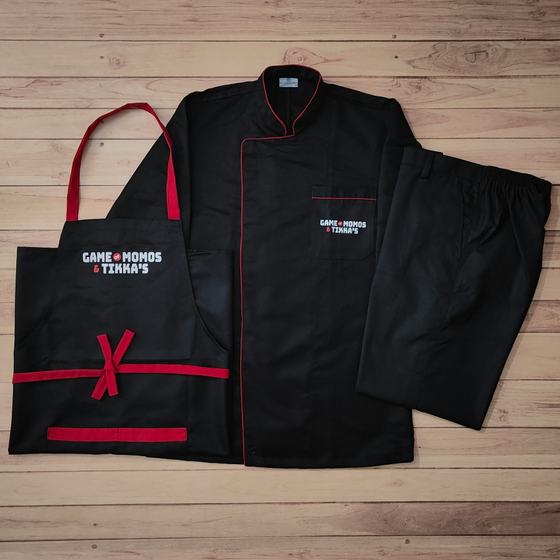 Black bib apron with red ties, black chef coat with red piping and black trousers with logo, custom made for Game of Momos by RestroCart, New Delhi