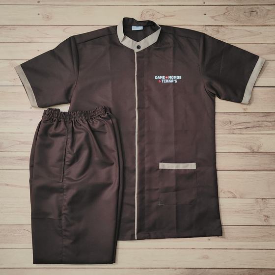 Brown housekeeping tunic with beige collar, cuffs and pocket trim, with brown trousers, custom made for Game of Momos by RestroCart, New Delhi