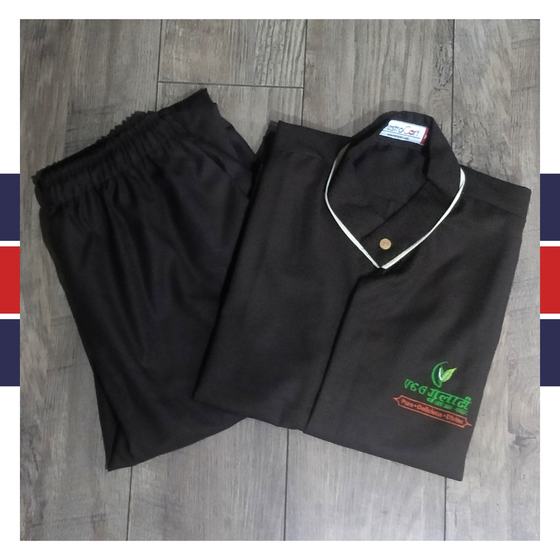 Black tunic with cream collar piping and green and red embroidered logo, with black trousers, custom made for Gulati by RestroCart, New Delhi