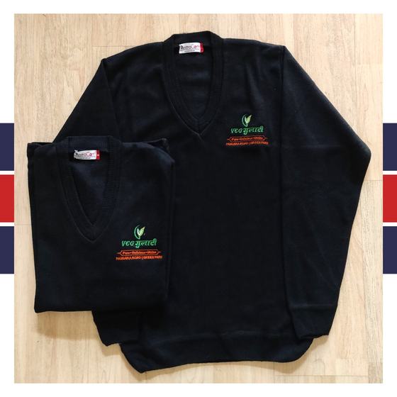 Two black V-neck knit sweaters with green and orange embroidered Hindi logo on chest, laid flat, custom made for Gulati by RestroCart, New Delhi