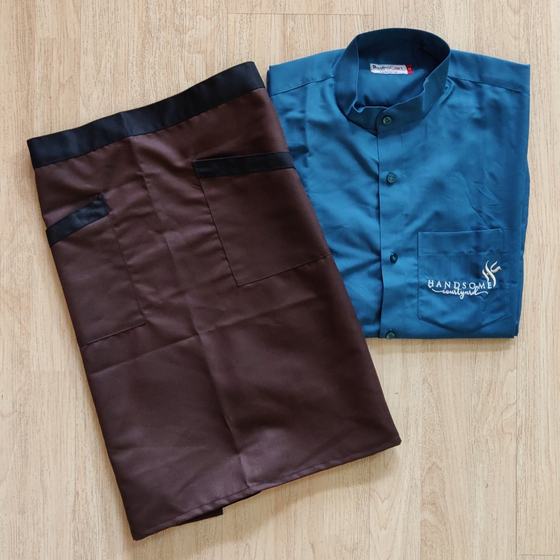 Brown waist apron with black waistband beside teal mandarin collar shirt with logo, custom made for Handsome Courtyard by RestroCart, New Delhi