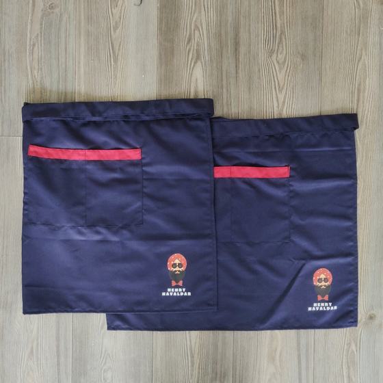 Two navy waist aprons with red pocket trim and printed turbaned mascot logo, custom made for Henry Havaldar by RestroCart, New Delhi