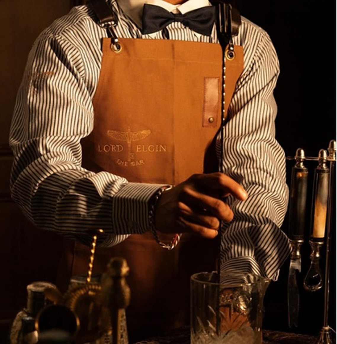 Bartender in customized RestroCart uniform with leather apron at Lord Elgin, Ludhiana