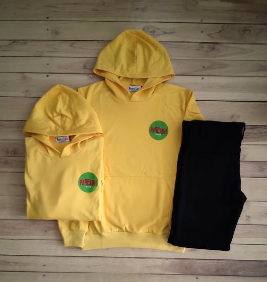 Yellow hoodies with round green logo patch paired with black joggers, folded, custom made by RestroCart, New Delhi