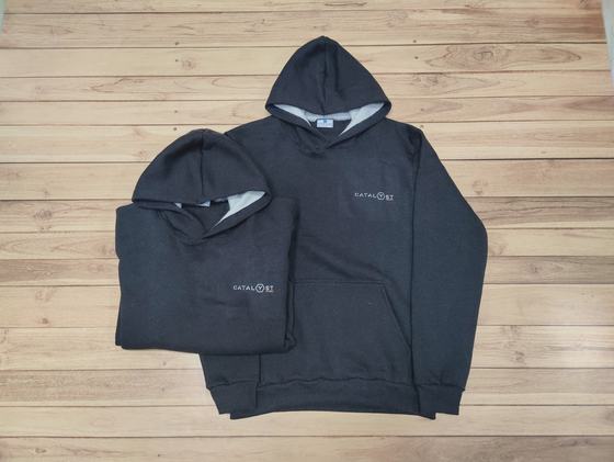 Charcoal hoodies with grey lined hood and small white chest logo, folded and laid flat, custom made by RestroCart, New Delhi