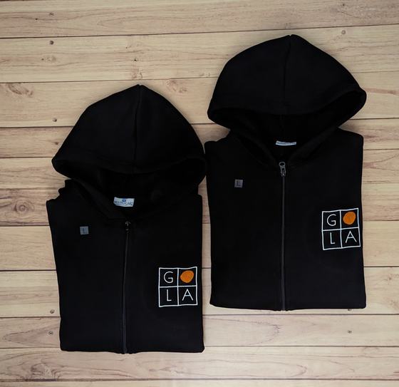 Two black zip-up hoodies with white and orange square grid logo on the chest, custom made by RestroCart, New Delhi