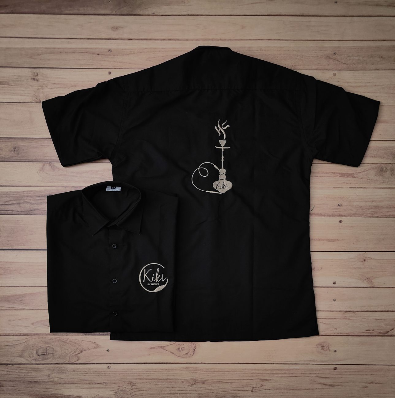 Black half-sleeve shirts with hookah line-art embroidery, custom hookah and shisha lounge staff uniforms by RestroCart